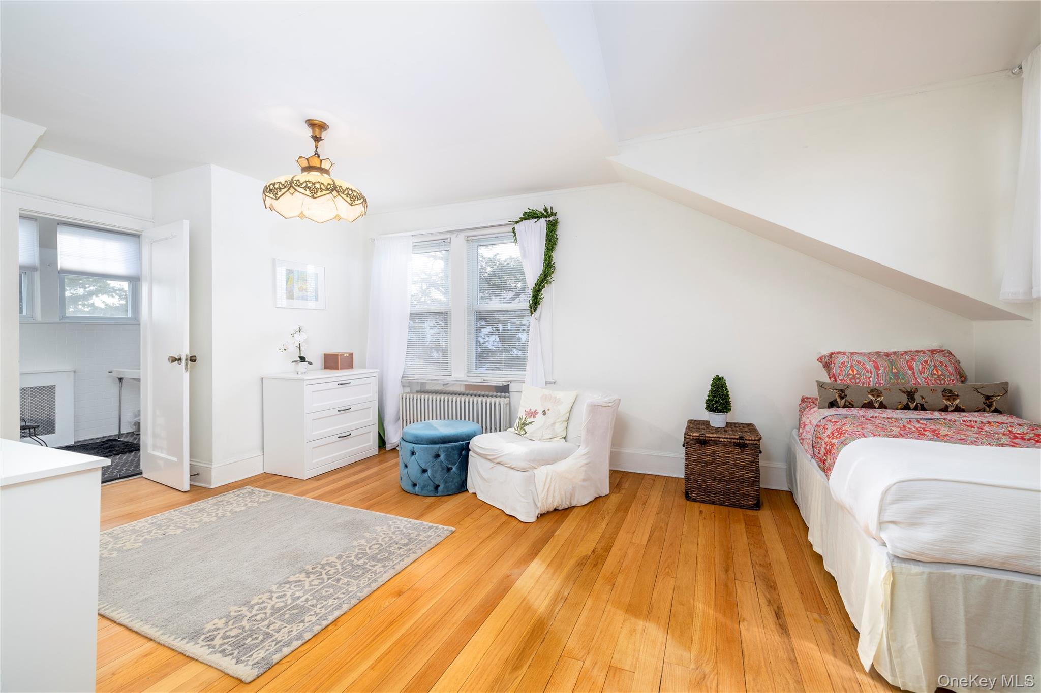 232 Sherman Street Lynbrook, NY 11563 - Photo 15 of 22 a bedroom with a bed and wooden floor