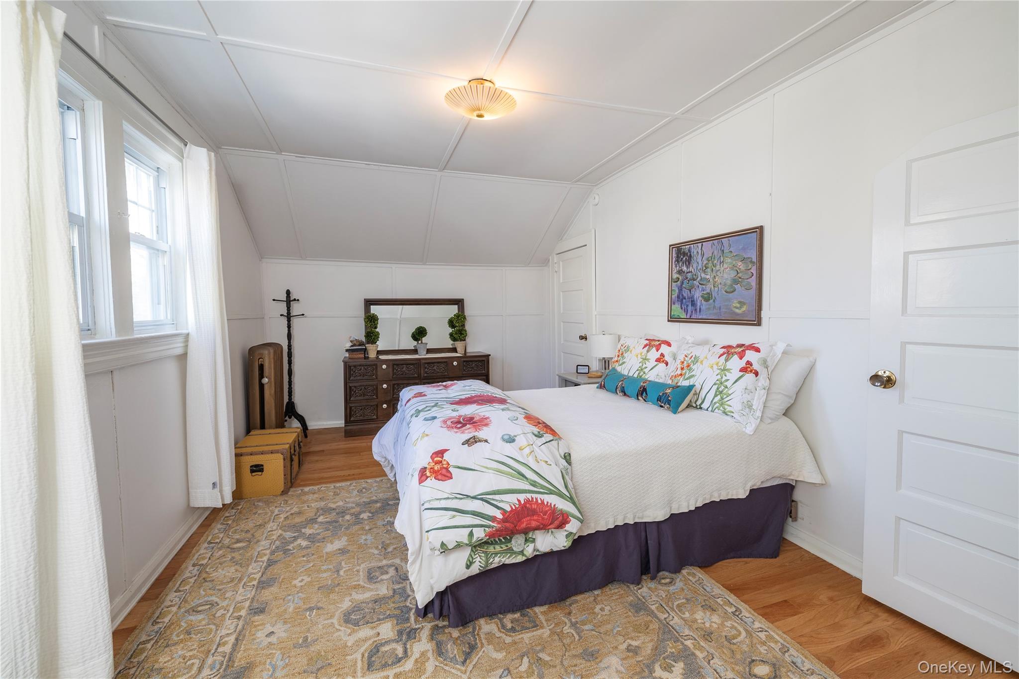 232 Sherman Street Lynbrook, NY 11563 - Photo 20 of 22 a bedroom with a bed and wooden floor