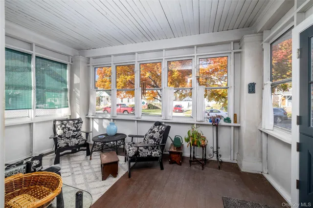 a very nice looking room with large windows and furniture