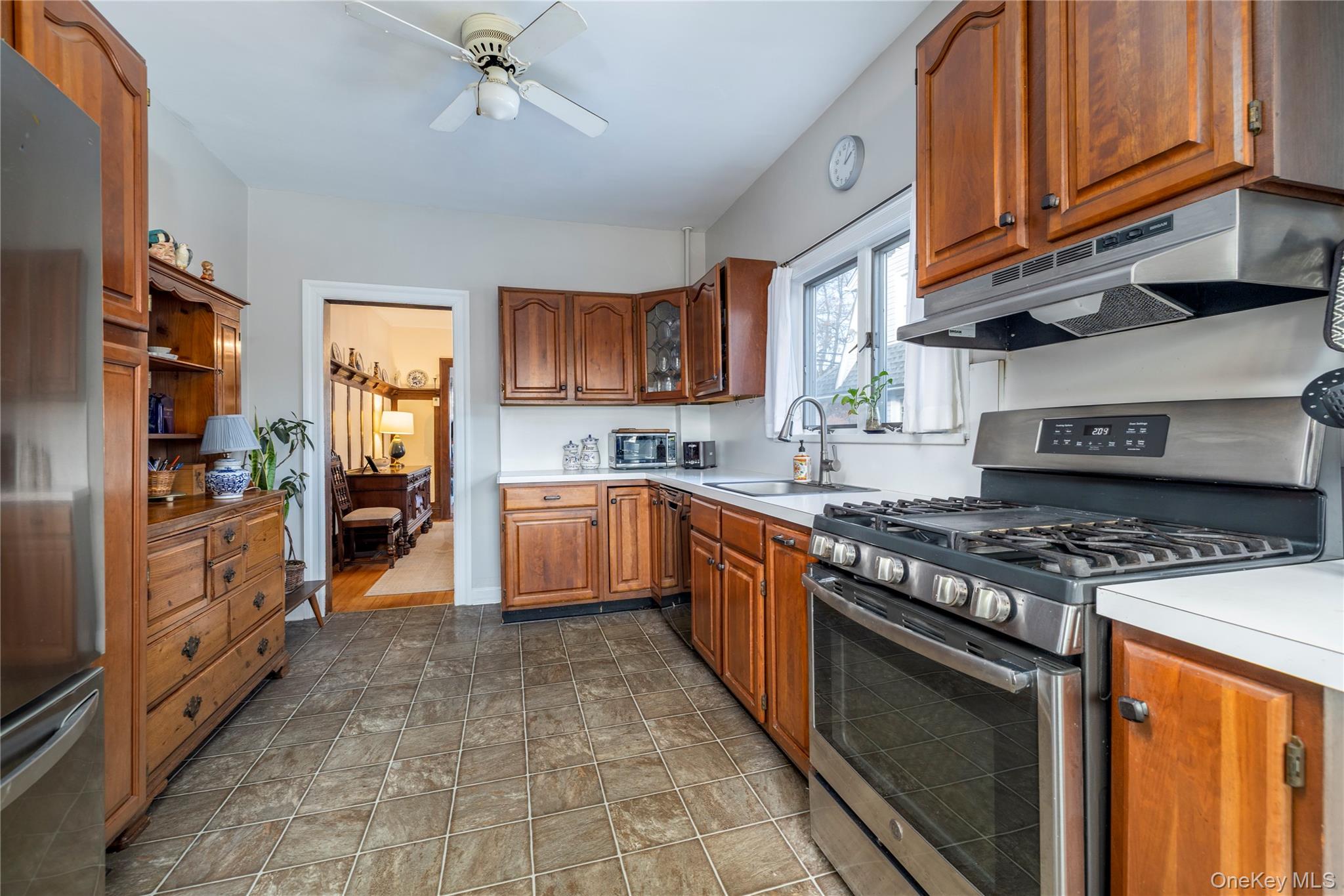 232 Sherman Street Lynbrook, NY 11563 - Photo 10 of 22 a kitchen with stainless steel appliances granite countertop a stove top oven a sink dishwasher and cabinets with wooden floor