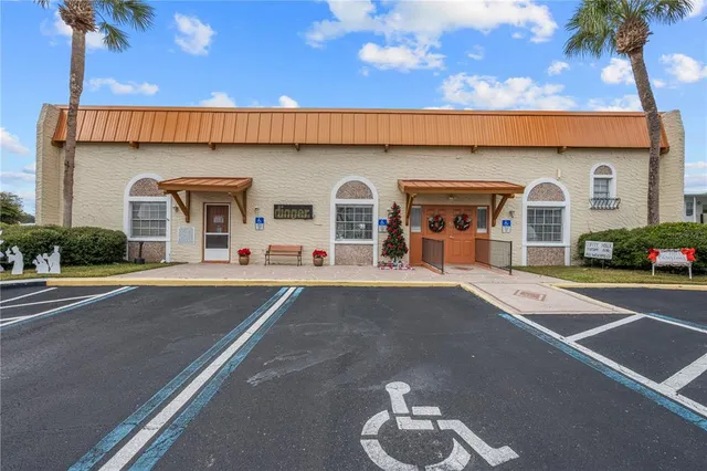 a front view of a building with parking space