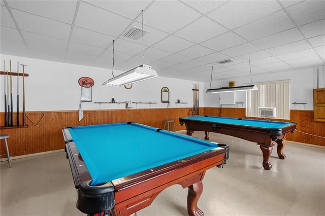 a room with furniture and pool table