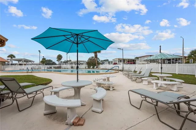 a view of a swimming pool with outdoor seating space