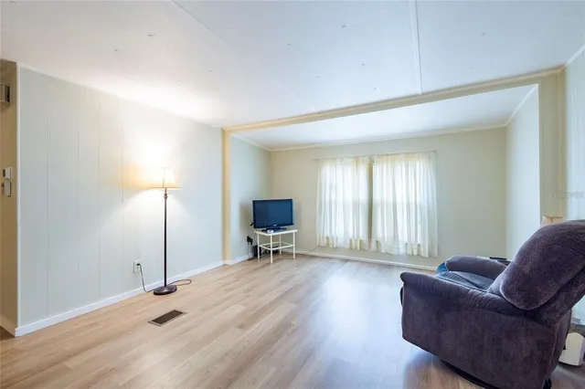a living room with furniture window and wooden floor