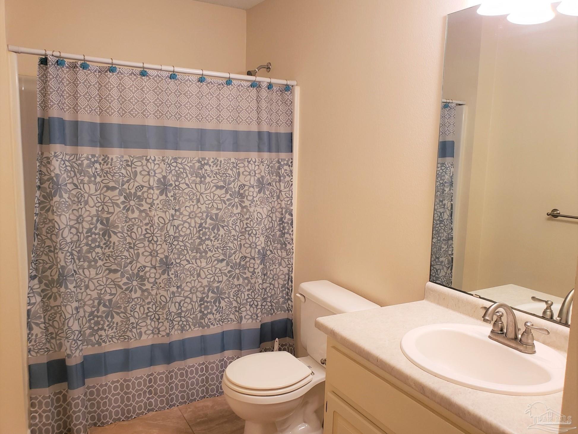 1767 Condor Drive Cantonment, FL 32533 - Photo 11 of 14 a bathroom with a sink toilet and shower