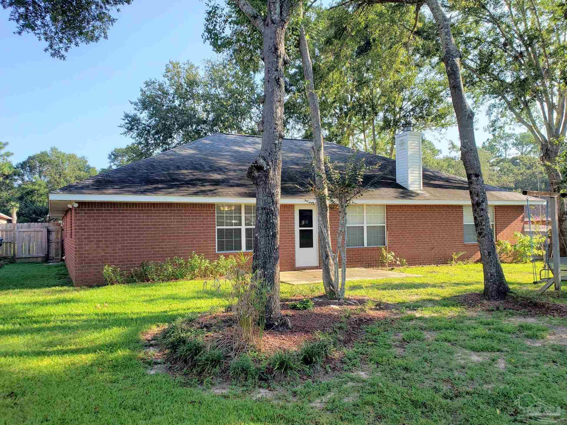 1767 Condor Drive Cantonment, FL 32533 - Photo 13 of 14 a view of a house with backyard and a tree
