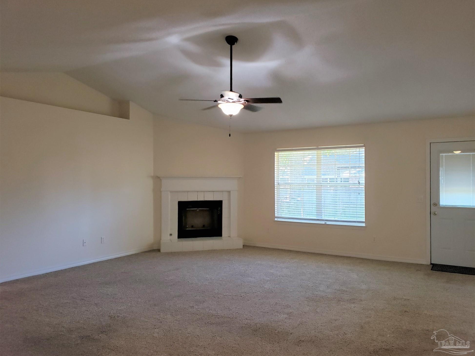 1767 Condor Drive Cantonment, FL 32533 - Photo 3 of 14 en empty room with windows and fireplace
