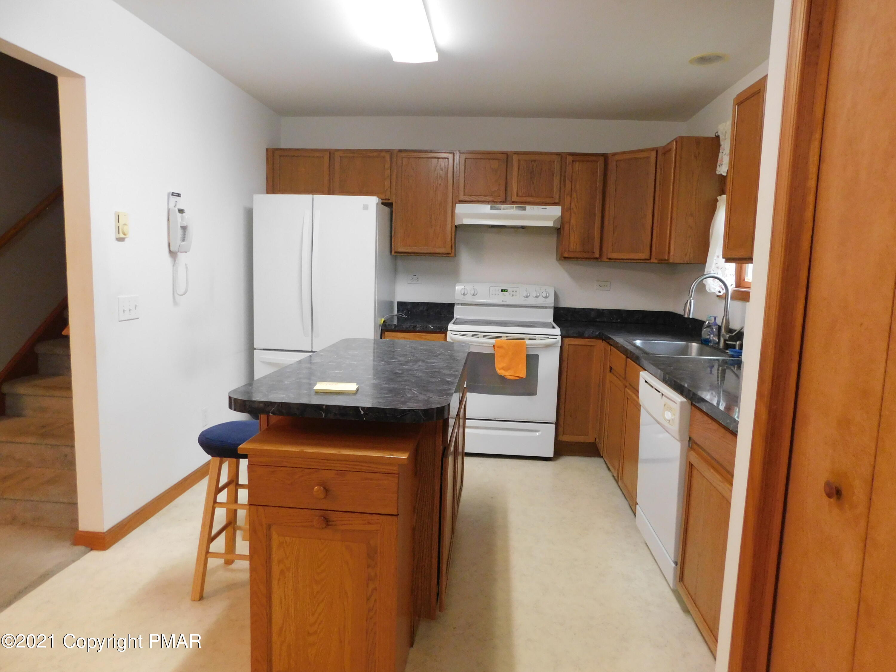 1051 Hampstead Road Bushkill, PA 18324 - Photo 27 of 40 a kitchen with stainless steel appliances a stove refrigerator sink and cabinets