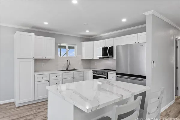 a kitchen with white cabinets and appliances