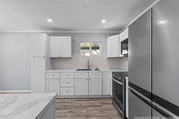 a view of a kitchen with dining room and wooden floor