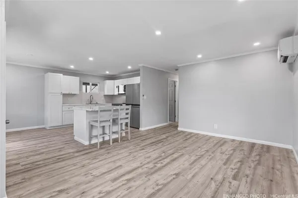 a view of a kitchen with dining room and wooden floor