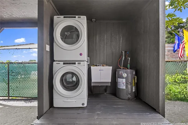 a kitchen with cabinets stainless steel appliances a sink and a window
