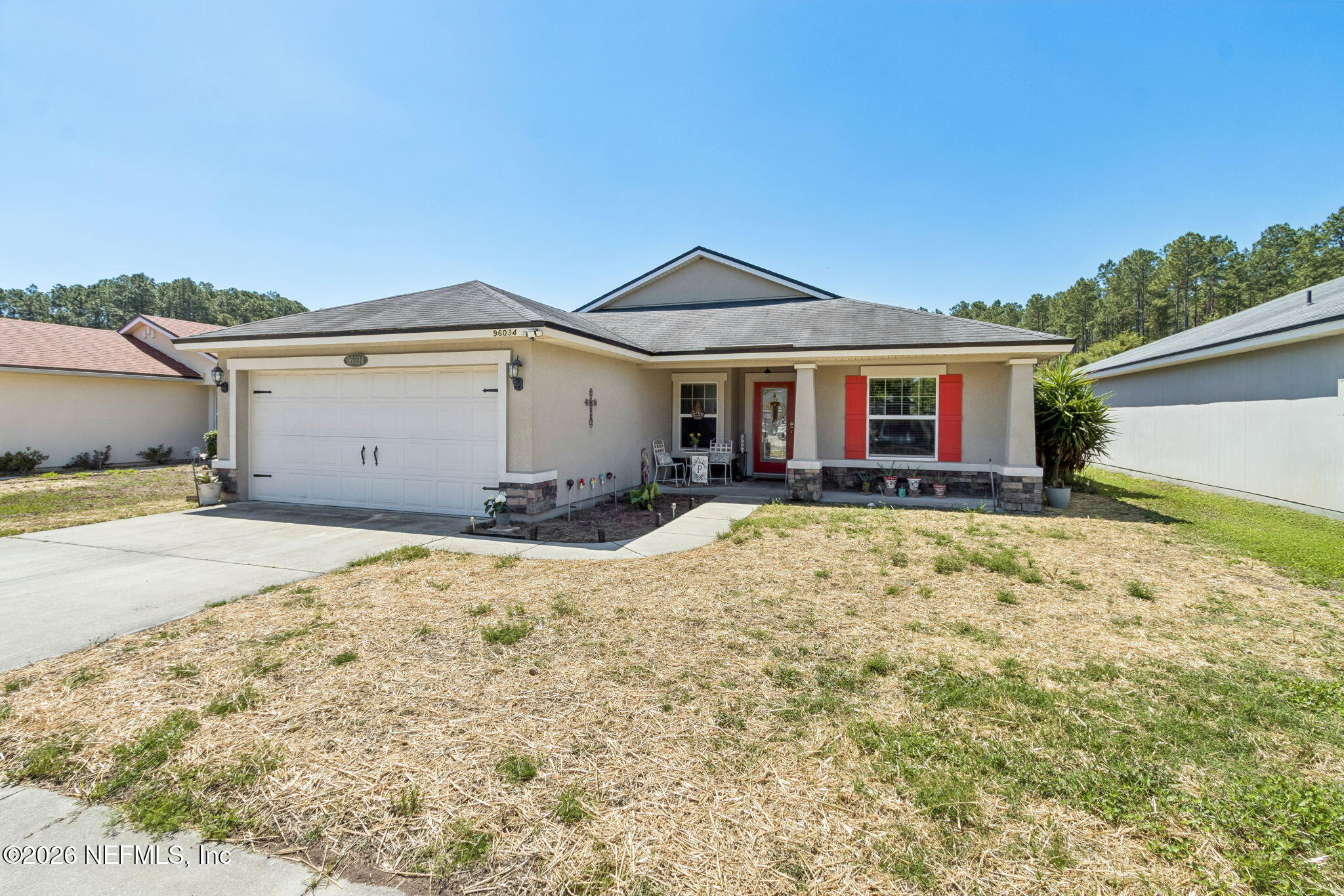 96034 Bass Lane Yulee, FL 32097 - Photo 3 of 50 a view of a house with a yard