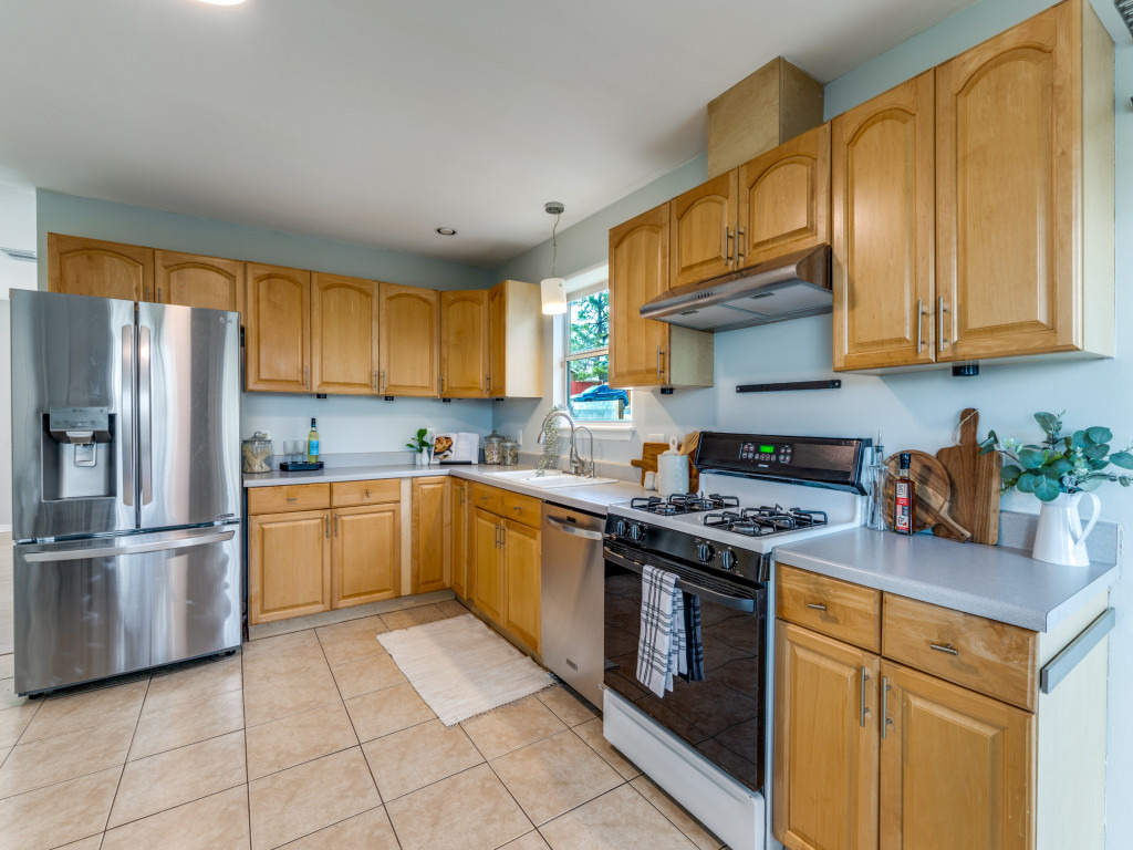 1705 Adriane Drive Austin, TX 78721 - Photo 6 of 31 a kitchen with stainless steel appliances granite countertop a stove top oven a sink and cabinets