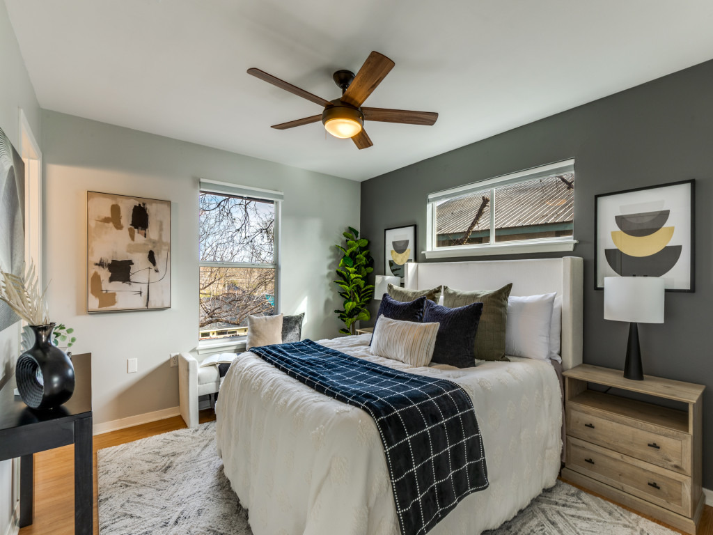 1705 Adriane Drive Austin, TX 78721 - Photo 8 of 31 a bedroom with a bed and a chandelier