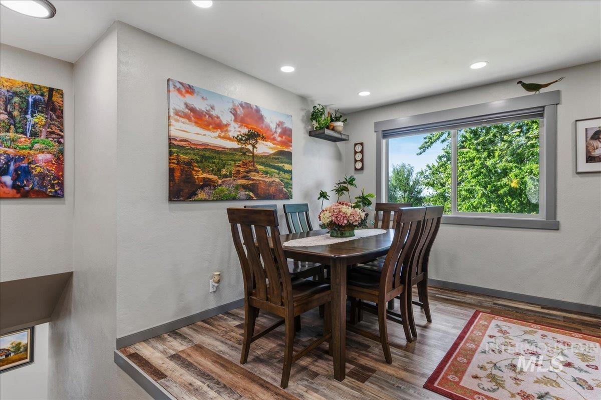 6323 Foothill Road Star, ID 83669 - Photo 10 of 50 Dining area featuring wood-finish flooring, recessed lighting, and a large window with gray trim