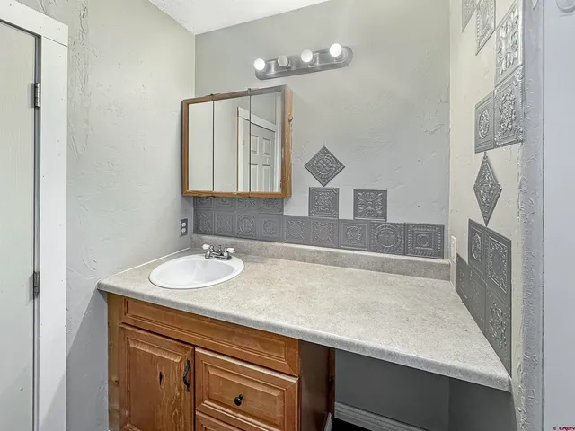 a bathroom with a sink a vanity and a mirror