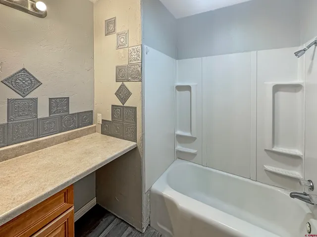 a bathroom with a bathtub and a sink