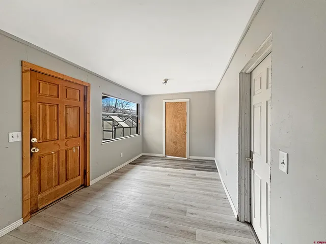 a view of an entryway with wooden floor