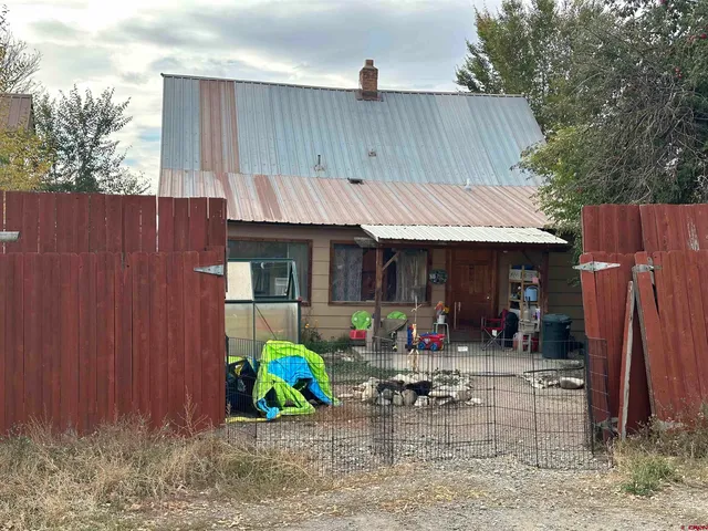 a view of a house with a snow in the yard