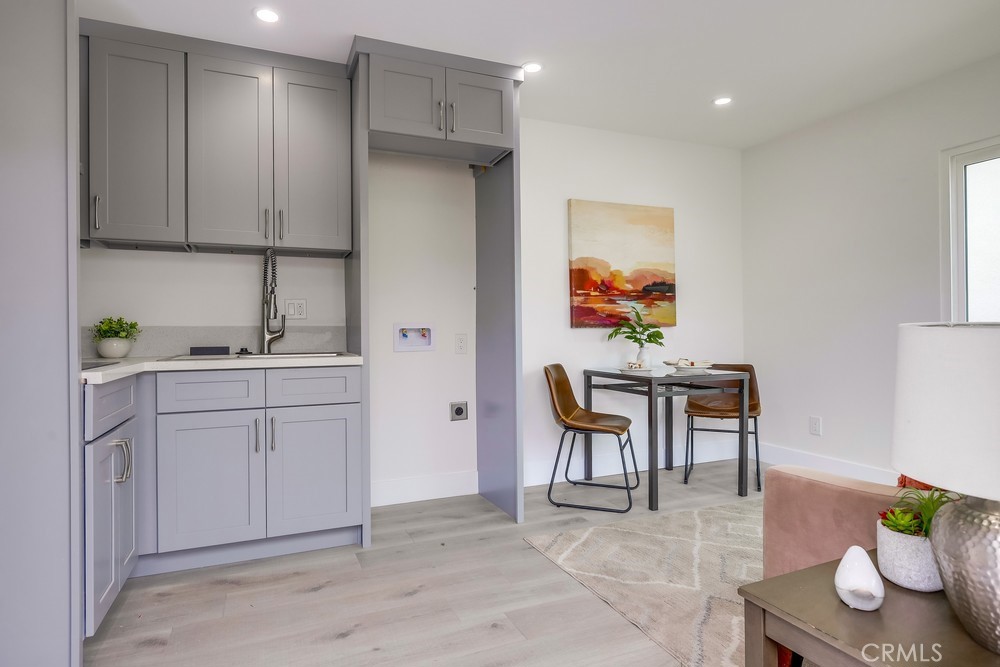 6441 A Mohawk Road Westminster, CA 92683 - Photo 8 of 15 a kitchen with a sink cabinets and dining table
