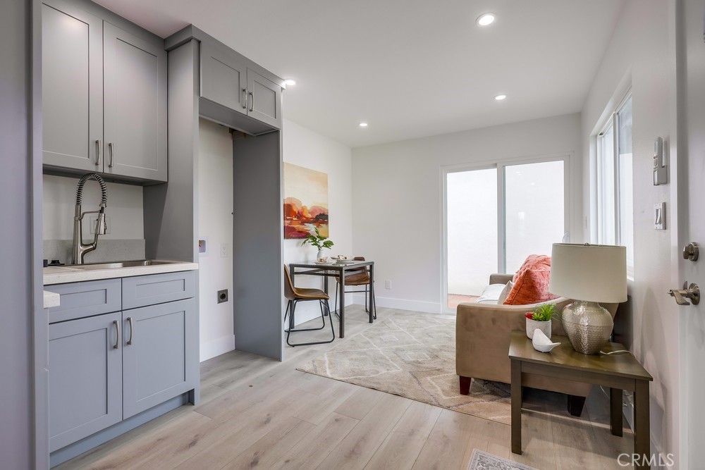 6441 A Mohawk Road Westminster, CA 92683 - Photo 9 of 15 a living room with furniture a desk and chair next to a window