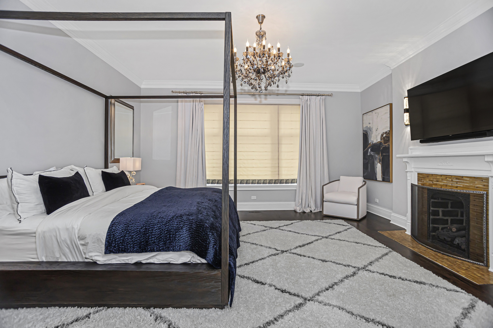 1302 North Ritchie Court Chicago, IL 60610 - Photo 12 of 31 a spacious bedroom with a bed and a flat screen tv