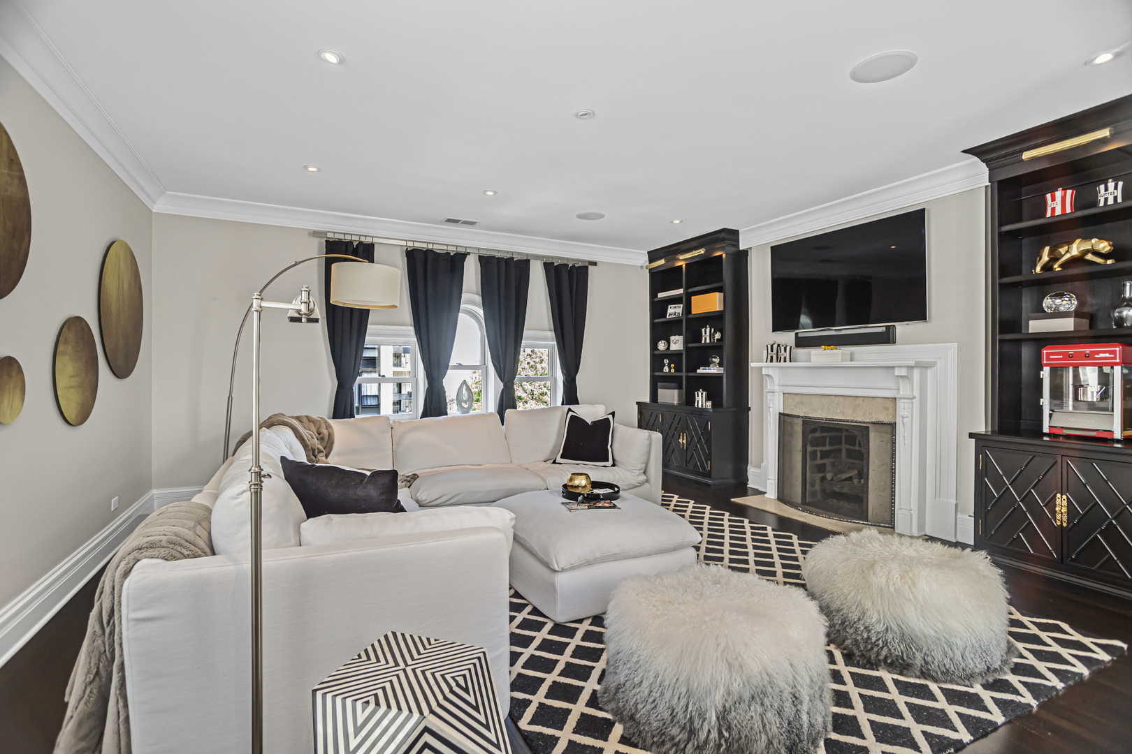 1302 North Ritchie Court Chicago, IL 60610 - Photo 22 of 31 a living room with furniture a flat screen tv and a fireplace