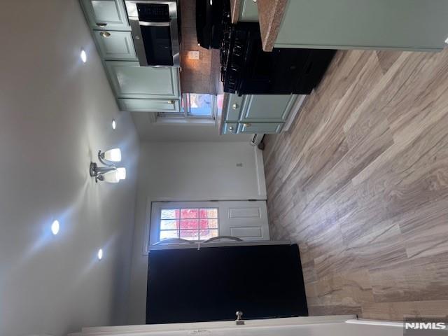 687 Probst Avenue Fairview, NJ 07022 - Photo 3 of 11 a kitchen with stainless steel appliances granite countertop a refrigerator a sink dishwasher a stove and a refrigerator