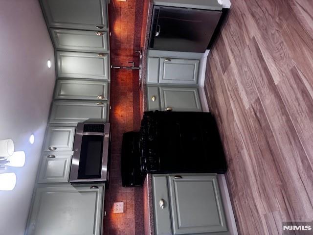 687 Probst Avenue Fairview, NJ 07022 - Photo 4 of 11 a kitchen with stainless steel appliances granite countertop a stove and a microwave