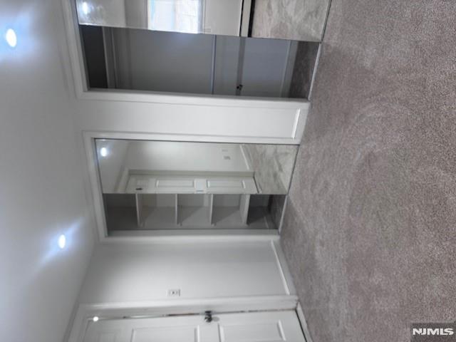 687 Probst Avenue Fairview, NJ 07022 - Photo 9 of 11 an empty room with a fireplace and cabinet