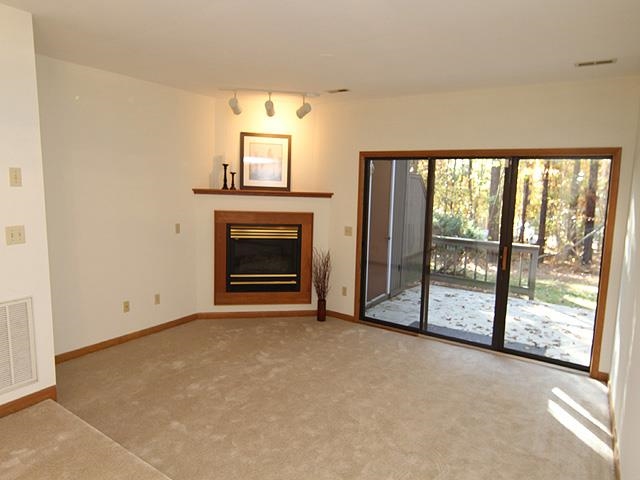 4313 Southwind Drive Raleigh, NC 27613 - Photo 7 of 16 Step down family room with gas log fireplace. Opens to private deck.