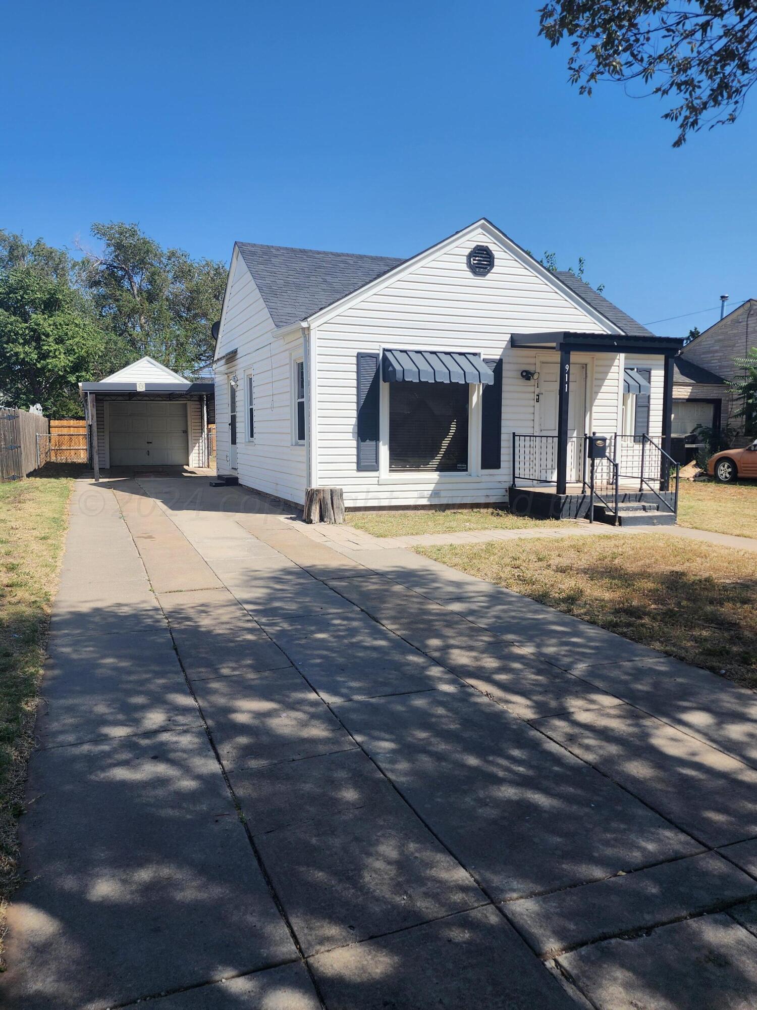 911 South Rusk Street Amarillo, TX 79102 - Photo 1 of 16 a front view of a house with a yard and garage