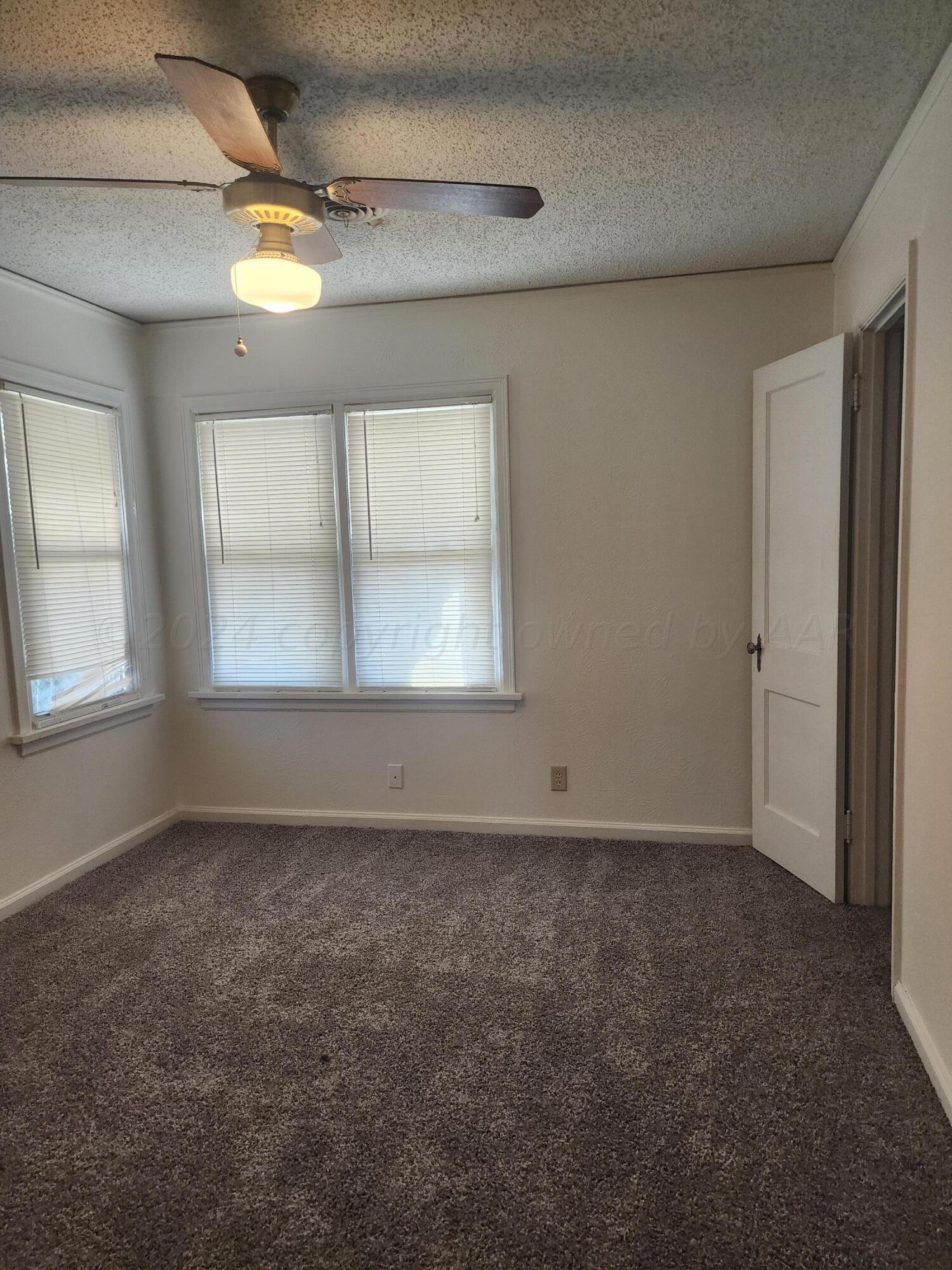 911 South Rusk Street Amarillo, TX 79102 - Photo 11 of 16 an empty room with a empty space and windows