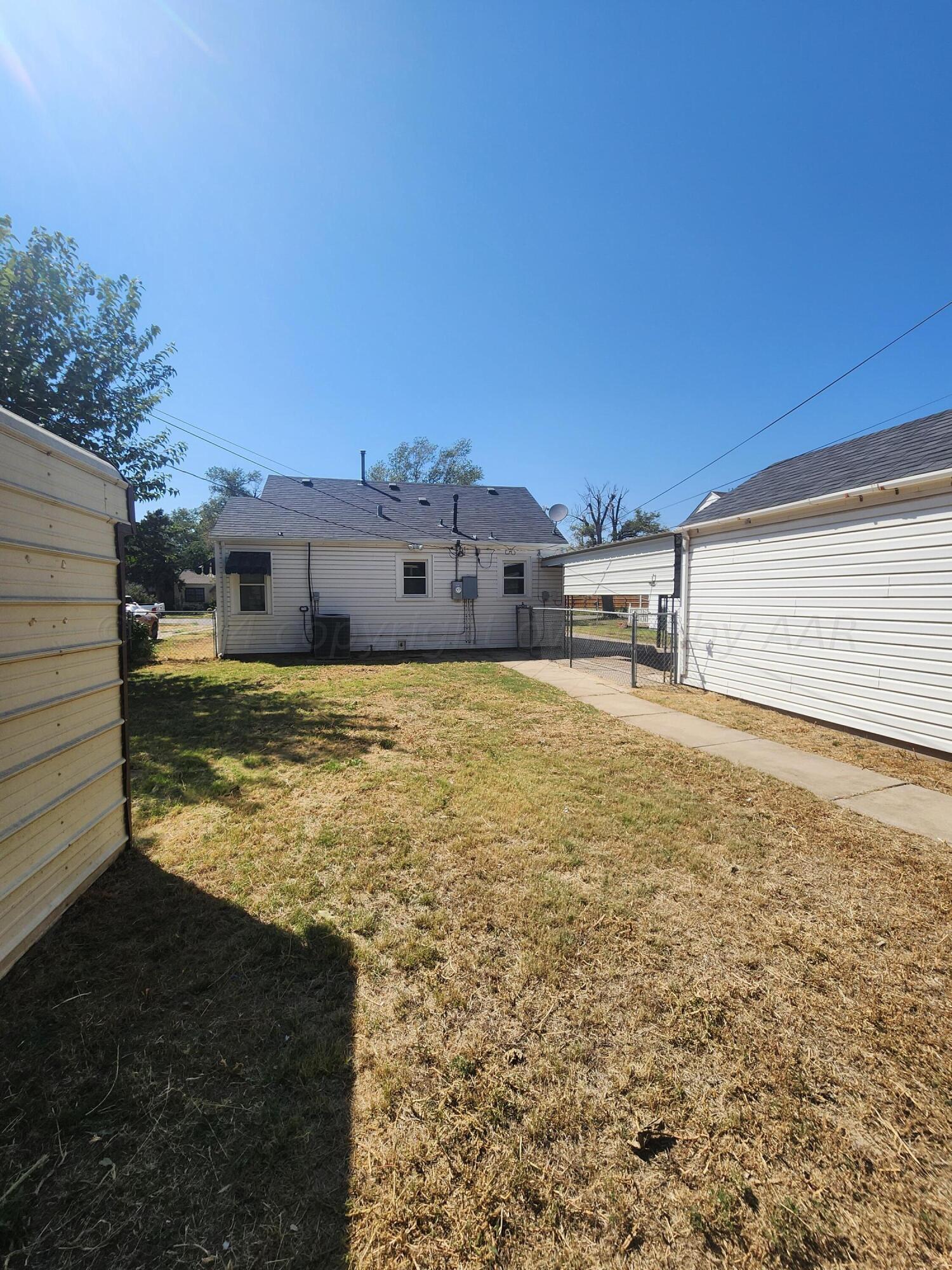 911 South Rusk Street Amarillo, TX 79102 - Photo 15 of 16 a view of a big yard with an house in the background
