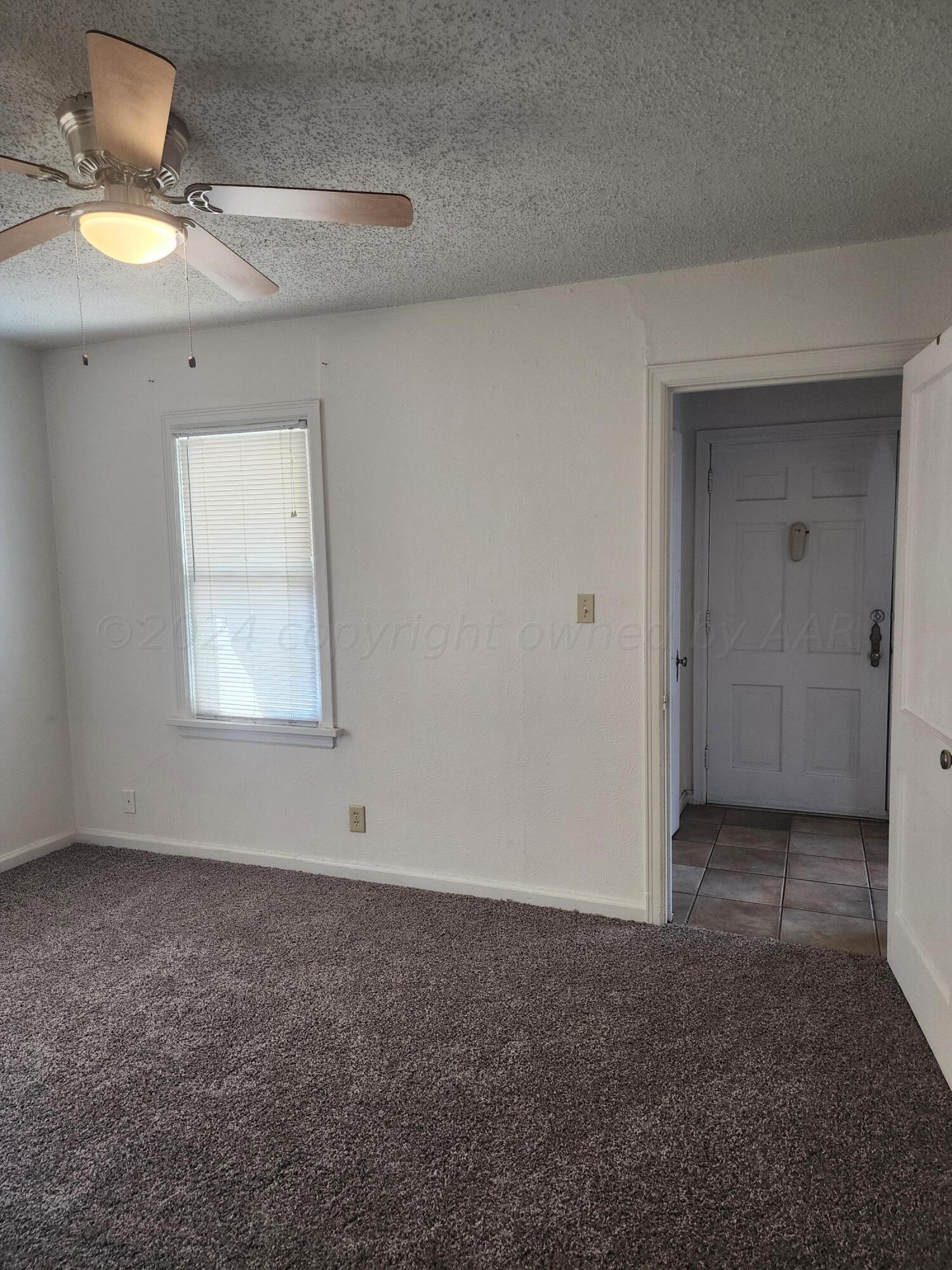 911 South Rusk Street Amarillo, TX 79102 - Photo 9 of 16 a view of an empty room with a window