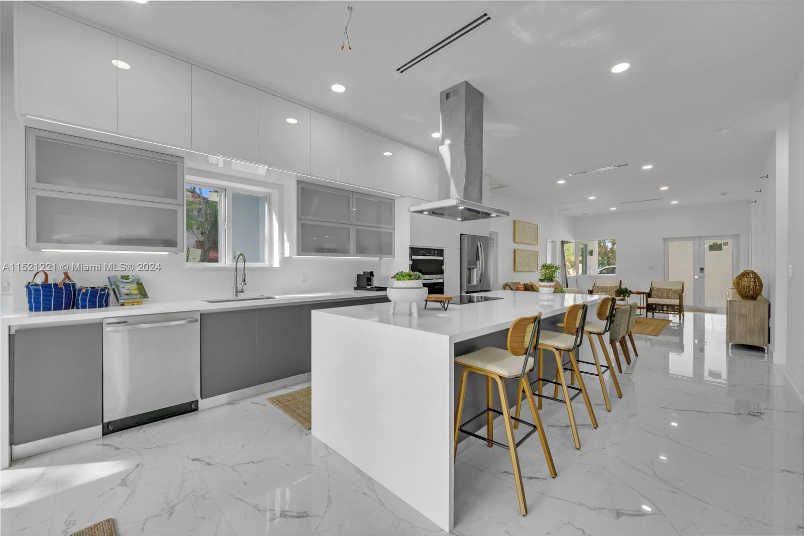 2356 Southwest 11th Street Miami, FL 33135 - Photo 17 of 51 an open kitchen with kitchen island a sink table and chairs