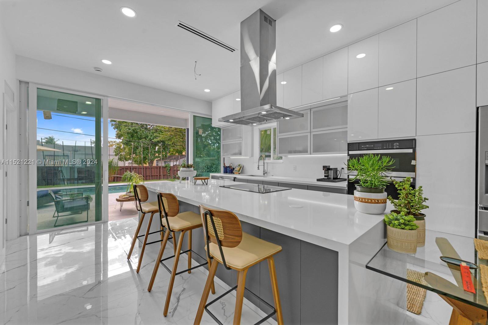 2356 Southwest 11th Street Miami, FL 33135 - Photo 19 of 51 a kitchen with a table chairs and white cabinets