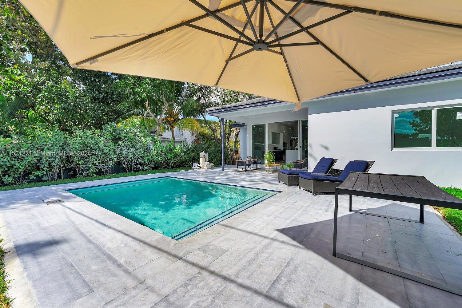 2356 Southwest 11th Street Miami, FL 33135 - Photo 28 of 51 a backyard of a house with yard and outdoor seating