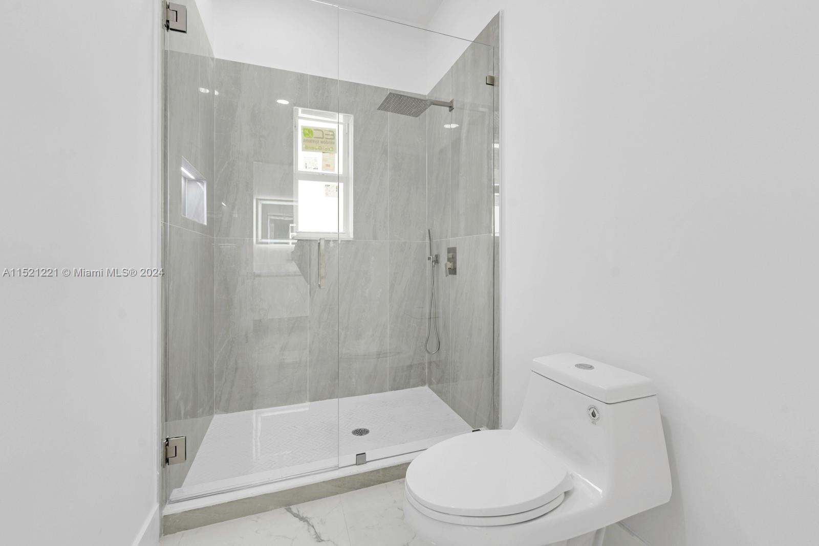 2356 Southwest 11th Street Miami, FL 33135 - Photo 38 of 51 a bathroom with a toilet and shower