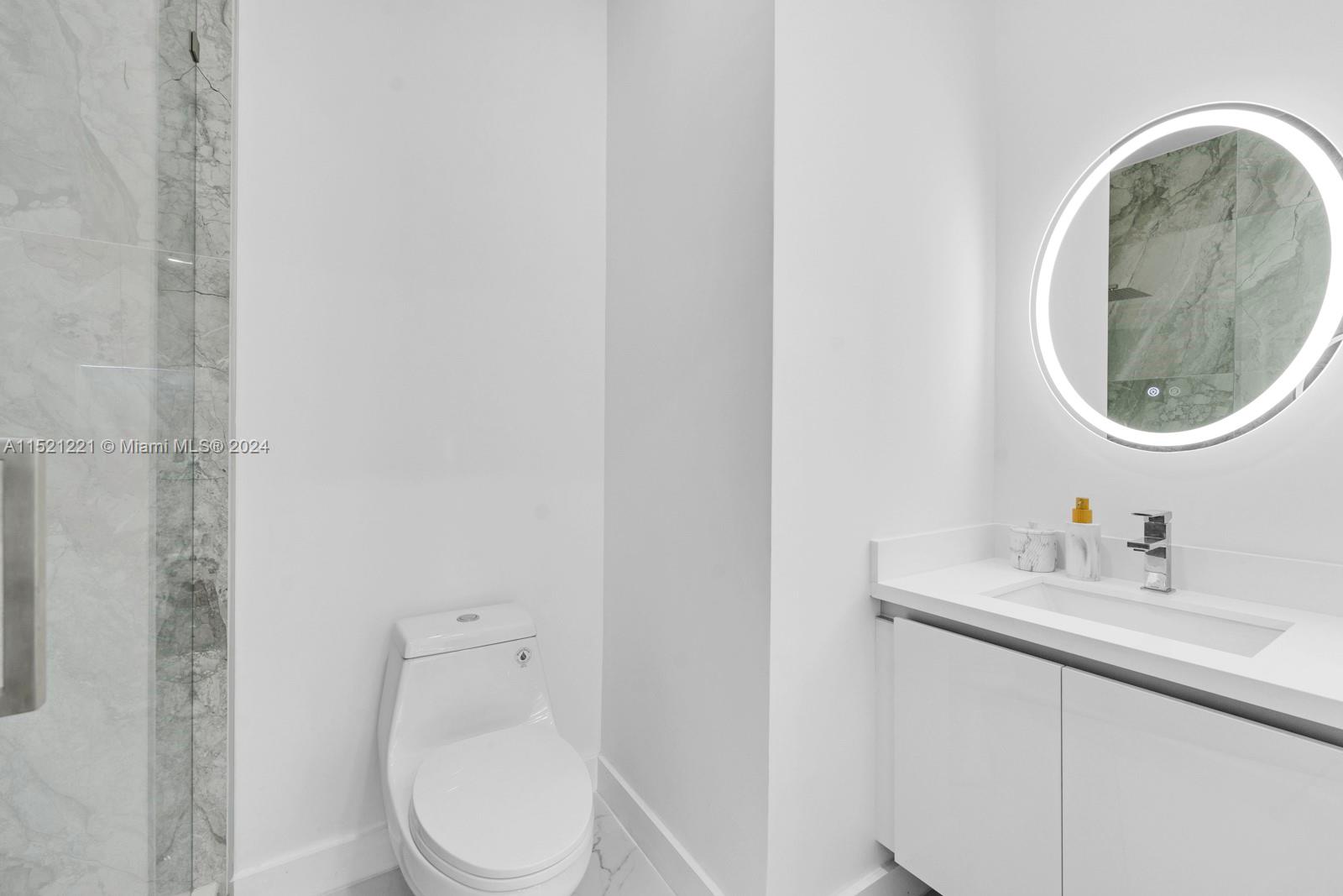 2356 Southwest 11th Street Miami, FL 33135 - Photo 50 of 51 a bathroom with a toilet a sink and mirror