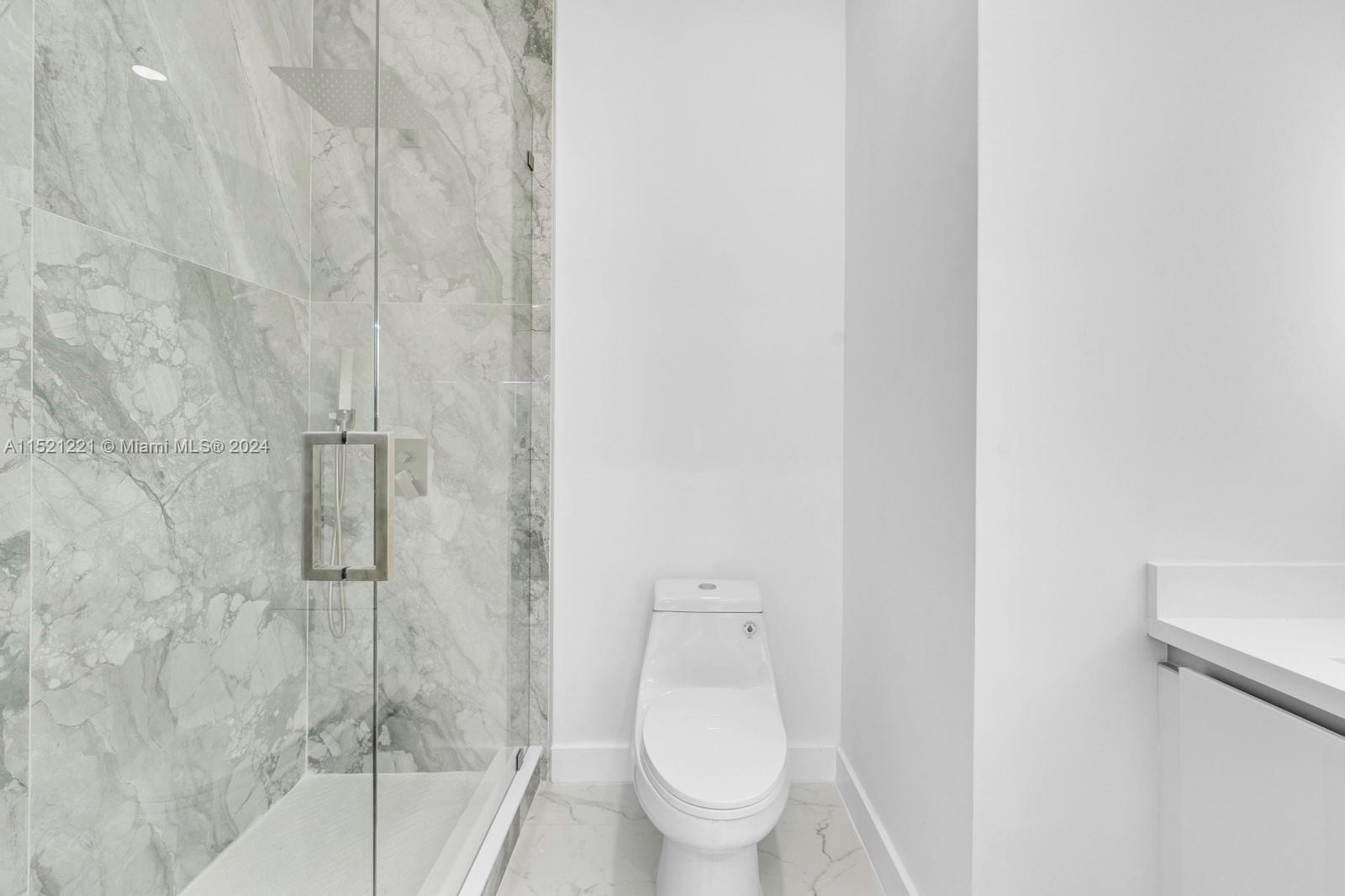 2356 Southwest 11th Street Miami, FL 33135 - Photo 51 of 51 a white toilet sitting next to a shower