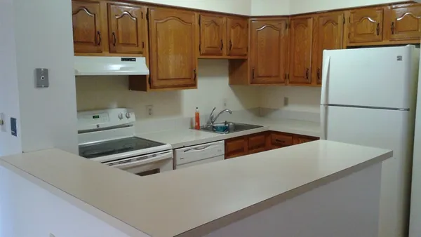 a kitchen with stainless steel appliances a refrigerator a stove a sink and cabinets