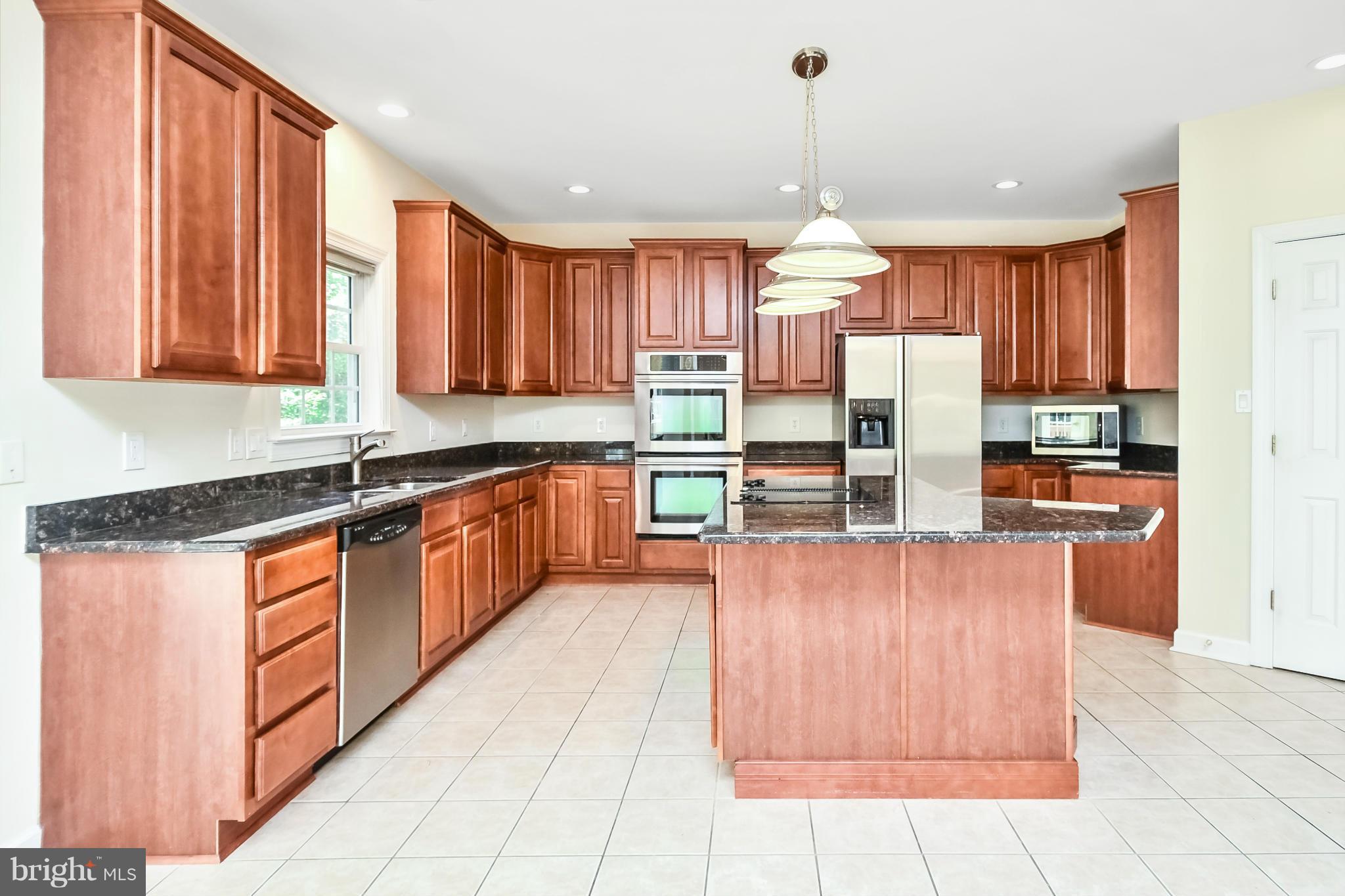 9 Johnson Mill Ridge Fredericksburg, VA 22406 - Photo 10 of 30 a large kitchen with kitchen island granite countertop a large counter top stainless steel appliances and cabinets