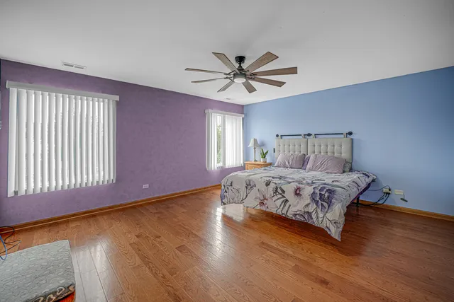 a spacious bathroom with a double vanity sink a mirror and a bathtub