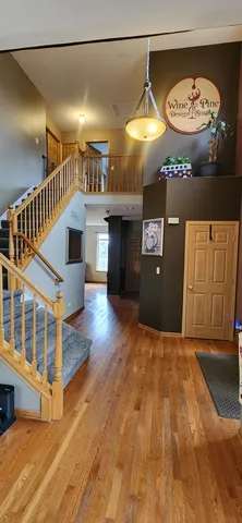 a kitchen with a table chairs microwave and cabinets