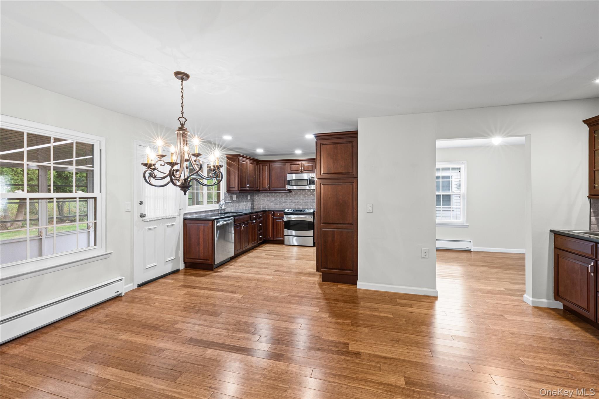 220 Belfast Lane Ridge, NY 11961 - Photo 20 of 44 a view of a kitchen with furniture and wooden floor
