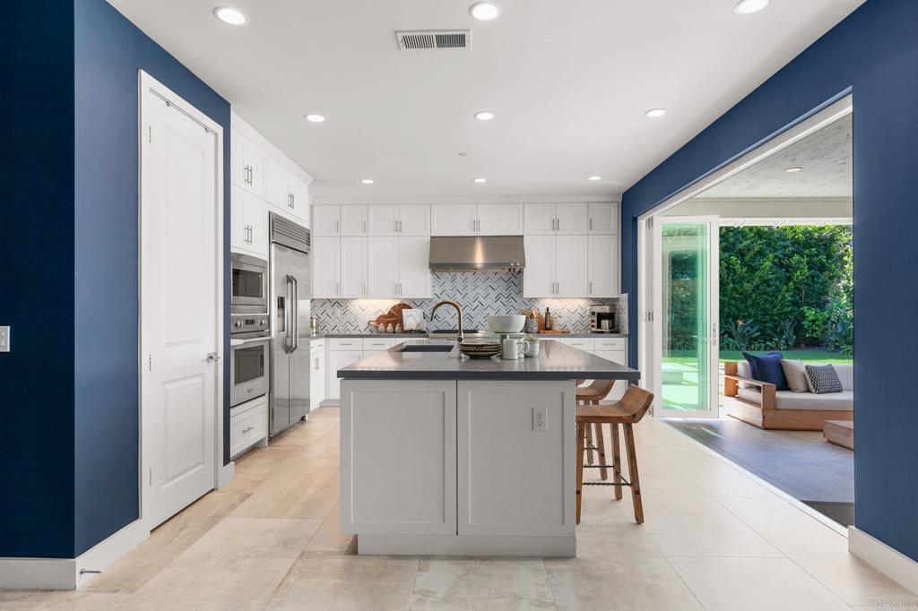 661 Jocelyn Way Encinitas, CA 92024 - Photo 7 of 21 a kitchen with stainless steel appliances granite countertop a stove and a refrigerator