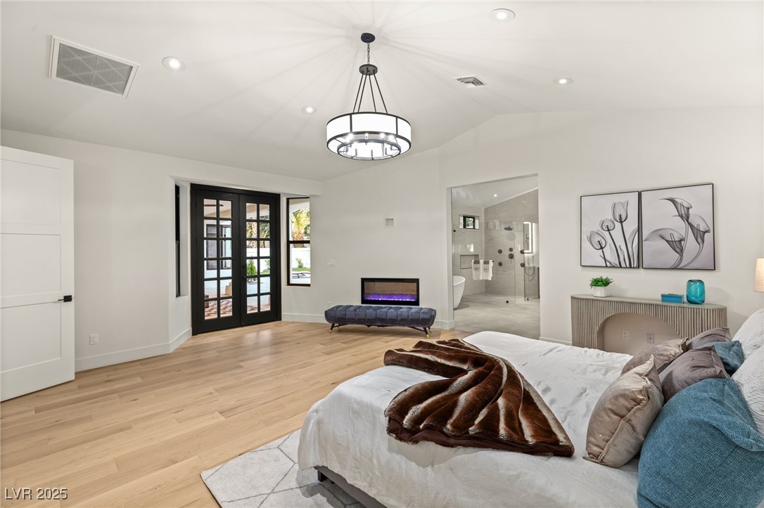 2316 Prometheus Court Henderson, NV 89074 - Photo 43 of 92 Bedroom featuring french doors, light wood finished floors, lofted ceiling, and visible vents