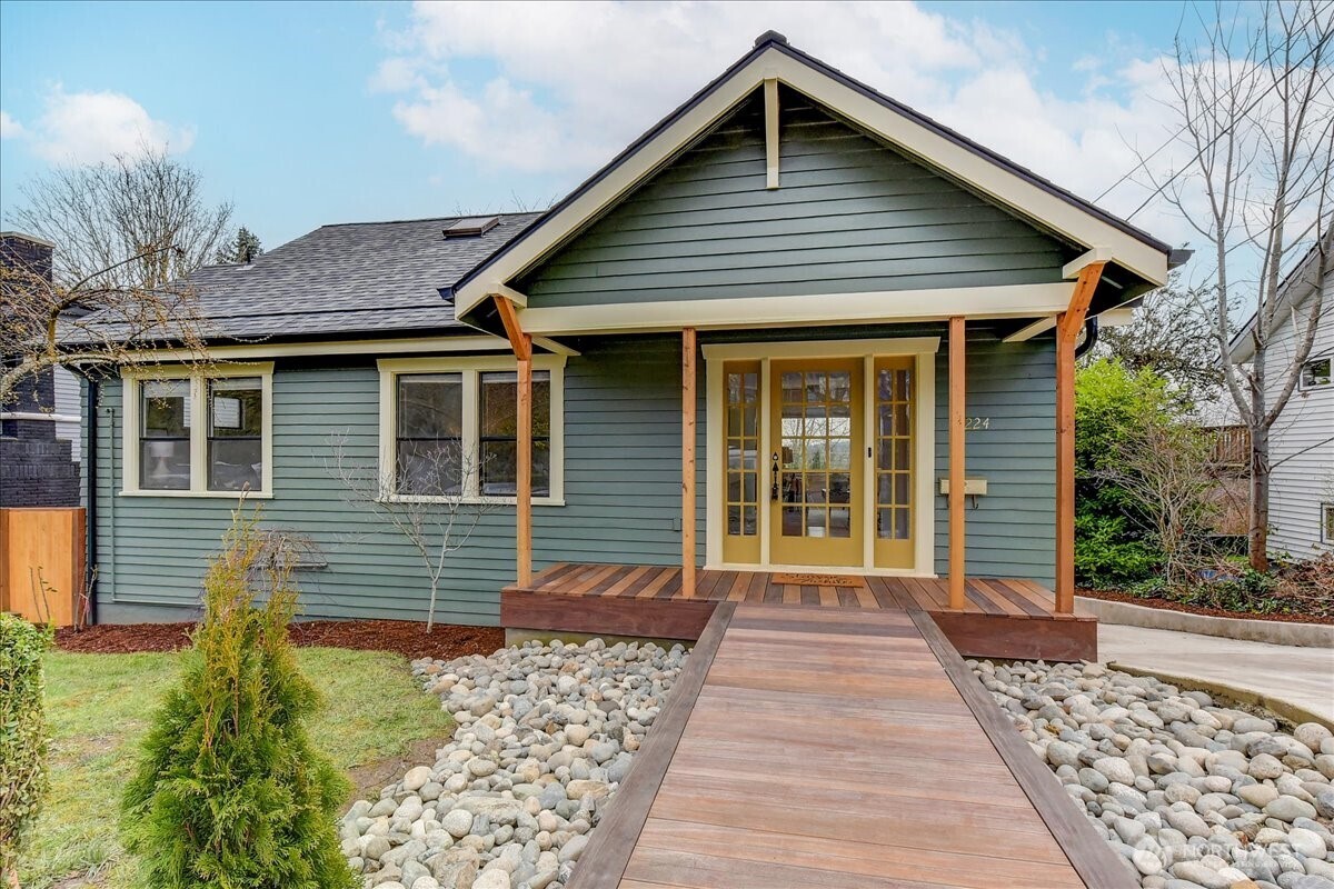 a front view of a house with a garden